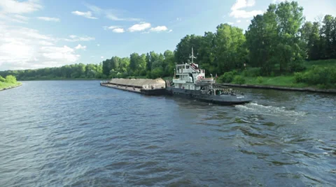 Barge with sand floats from left to right Stockbeeldmateriaal 35663889