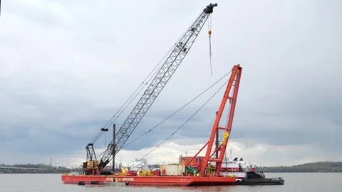 Barge transporting crane as Key Bridge wreckage removal continues Video stock 271338686