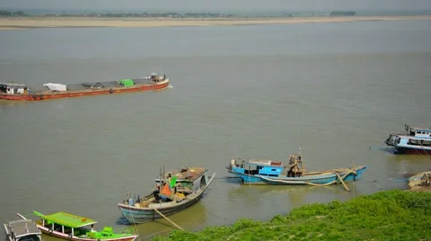 Barge transporting goods by river near small boats. Stockbeeldmateriaal 40975891