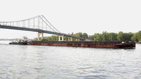 Barge on the water passes under the bridge in 4K. Stock Footage 154744672