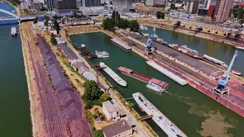 Barges and cranes at a dock area with buildings and water in the city Stock-Footage 343125610