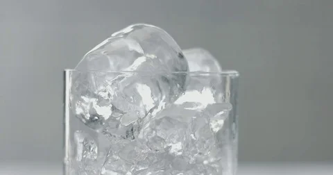 Barist puuts an ice cube in glass Stock Footage 77644522