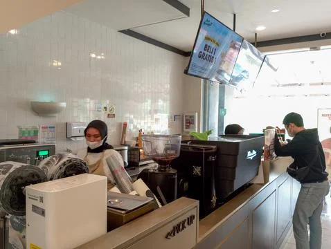 Barista in Action: Preparing Drinks at a Modern Café's Pick-Up Counter Stock Photos