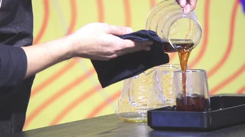 Barista add ready Drip coffee to drink in cup. Stock Footage 107409348