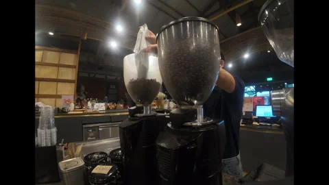 Barista Adding Coffee Beans to Grinder in Slow Motion before Café Opening Stock Footage 310787802