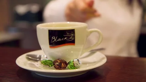Barista at the Bar Serves Coffee in a Coffee Cup and Candy on a Saucer. Stock Footage 306400829