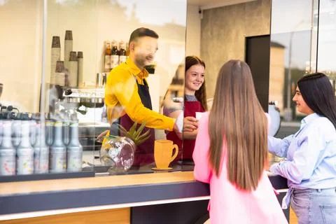 Barista cafe or bartender serving coffee to customer at coffee shop with happy Stock-Fotos