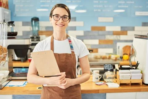 Barista checking the information in the notepad. Stock Photos