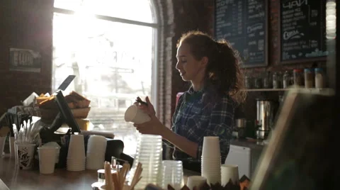 Barista Coffee House wrote the name on the cup and smiling Stock Footage