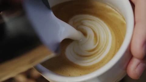 Barista creates coffee art Stock Footage 274686538