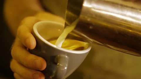 Barista Creating Latte Art by Pouring Steamed Milk Into Coffee Cup in Sydney Stock Footage 345692020