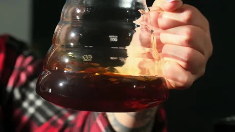 Barista dissolves coffee in water using glass carafe Stock-Footage 306581670