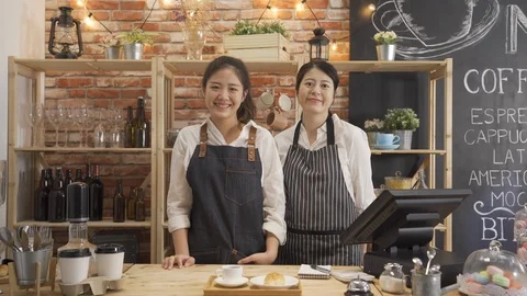 Barista face camera smiling  in modern cafe store Video stock 118799082