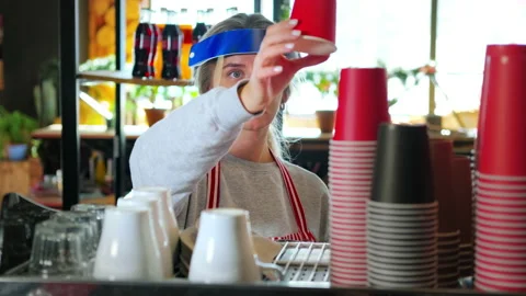 Barista in face shield making takeaway coffee. COVID-19 service restrictions Stock Footage 157231617
