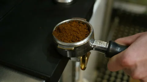 Barista forms a coffee tablet in a holder - behind the bar Stock Footage 62446628