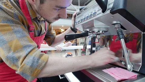 Barista gently wipes a coffee machine in a coffee shop Stock Footage 95779004