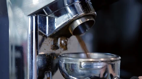 Barista grinding coffee beans using coffee grinder and holder. Hands close-up. Stock Footage 103051096