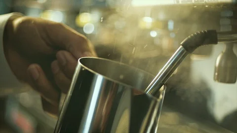 Barista hand making foaming and steaming coffee milk at machine in slow motion Stock Footage 103809675