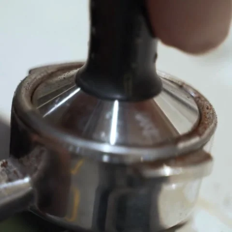 Barista Hand Pressing Coffee Grounds with Tamper in Portafilter for Espresso Stock Footage 322523669