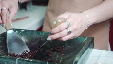 Barista hand roasting coffee beans with fire and herbal liqueur on stone surface Stock Footage 336563684