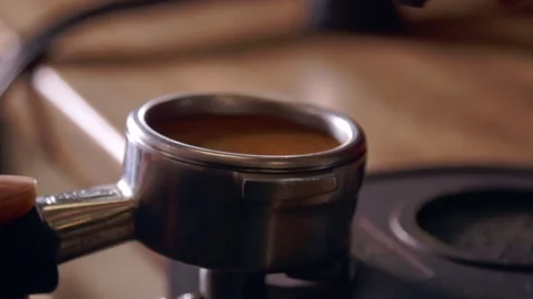 Barista hands making preparing espresso shot using leveling tool and tamper Stockbeeldmateriaal 139355465