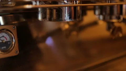 Barista inserts a horn with ground coffee into a professional coffee machine Stock Footage 85779694
