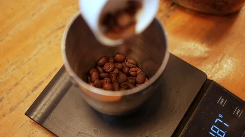 Barista makes aeropress step by step. Barista weighs coffee beans on a scale for Stock Footage