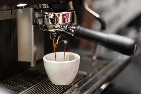 Barista makes coffee in a coffee machine Stock Photos