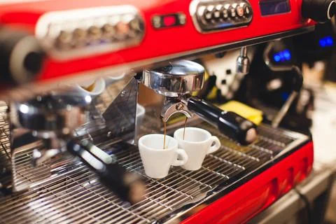 Barista makes coffee in a coffee machine Stock Photos