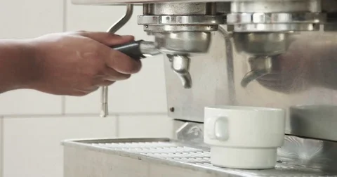 Barista makes espresso in a professonal coffee machine Stock Footage 77644144