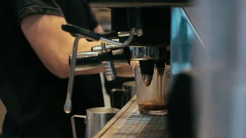 Barista making coffee in coffee machine at a busy coffee shop Stock Footage 84516774