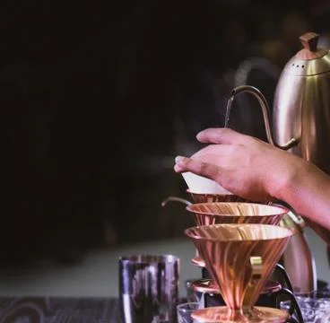 Barista is making coffee, coffee preparing with chemex, Chemex Dripping hot f Stock Photos