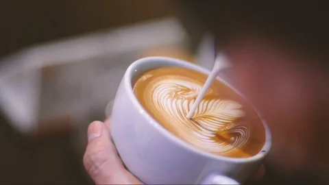 The barista is making coffee, Pour the Latte Art, Rosetta Stock Footage