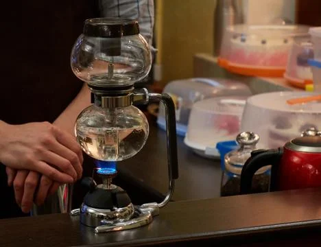 Barista making coffee using special glass jar Stock Photos