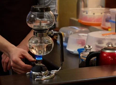 Barista making coffee using special glass jar Stock Photos