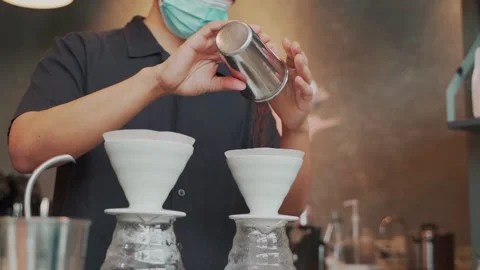 Barista man making craft filter drip coffee at bar in coffee shop. Stock Footage 159401670
