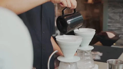 Barista man making craft filter drip coffee at bar in coffee shop. Stock Footage 159401678