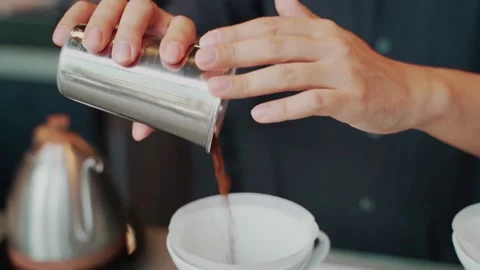 Barista man making craft filter drip coffee at bar in coffee shop. Stock Footage 159401729