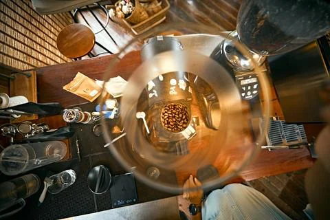Barista operating grinder Stock Photos