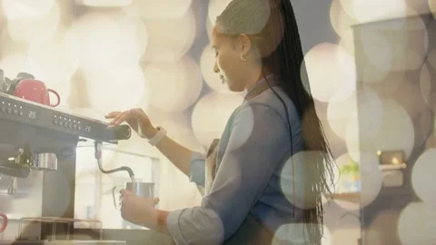 Barista placing milk pitcher under steam wand, turning knob, steaming milk for Stockbeeldmateriaal 333975518