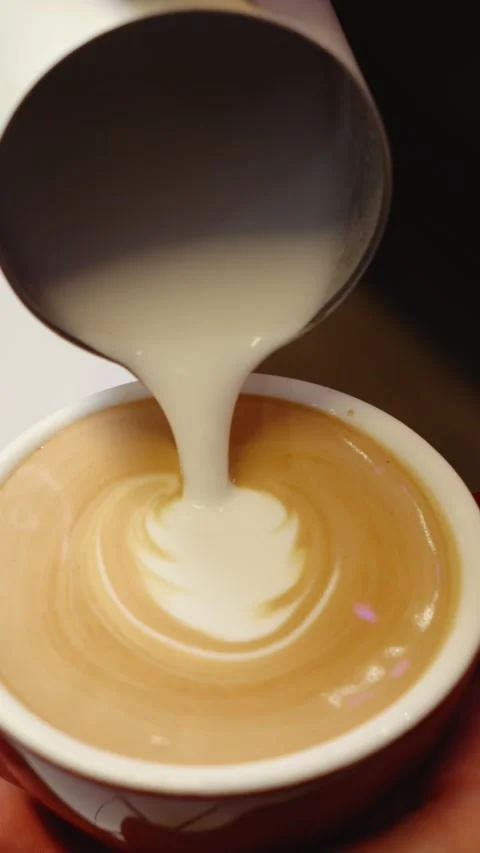 Barista Pouring Milk to Create Latte Art Stock Footage 343760147