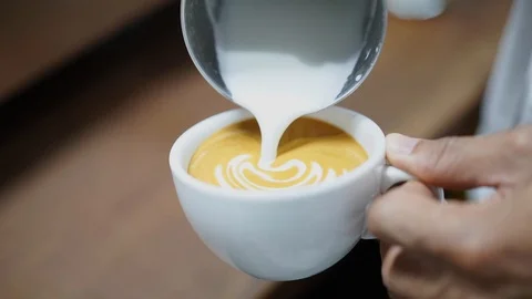 Barista practice on making beautiful latte art at cafe Stock-Footage 93118552