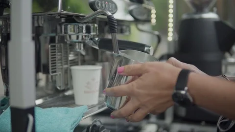 Barista is preparing coffee. Steaming and frothing milk for cappuccino or latte. 動画素材 116333440