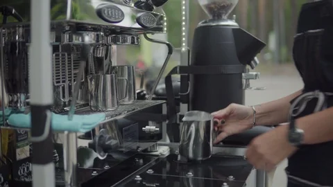 Barista is preparing coffee. Steaming and frothing milk for cappuccino or latte. 動画素材 116334524
