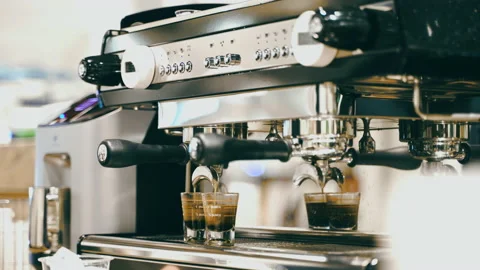 Barista preparing espresso by coffee machine making latte in cafe Video stock 155446882
