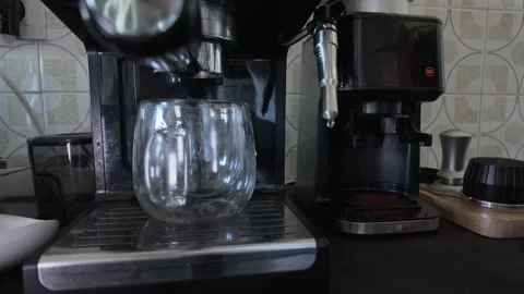 Barista preparing fresh espresso coffee with a home coffee machine Stock Footage 334848322