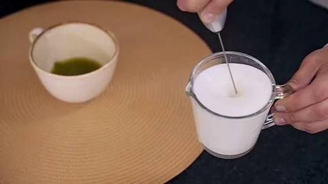 Barista Preparing Steamed Milk for Matcha Green Tea Latte Video stock 313588141
