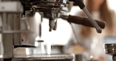 Barista preparing two espressos on coffee machine in busy cafe, skimming milk Stock Footage 80220296