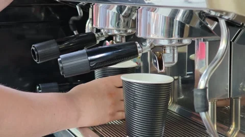 Barista preparing two takeaway coffees with professional espresso machine Stockbeeldmateriaal 310307003