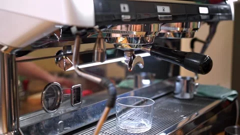 Barista presses button on coffee machine initiating process Stock Footage 272785896